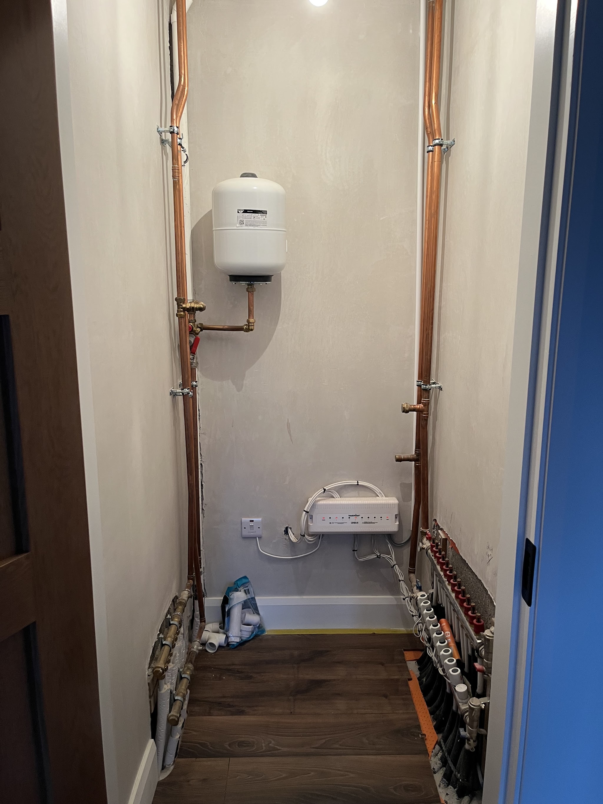 Plant cupboard with copper pipework, an expansion vessel and a heating manifold